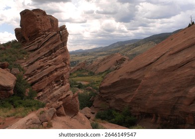 The image captures the intriguing depth of a red rock canyon landscape, exemplifying the geological formations and natural beauty that highlights Colorado's iconic terrain.