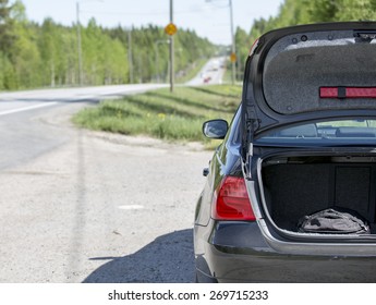 An Image Of A Car Trunk Open Waiting For Help.