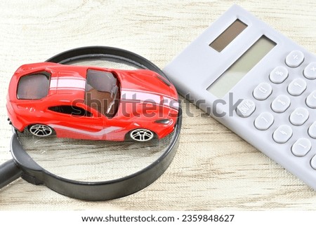 Image of car valuation with a car, a magnifying glass and a calculator