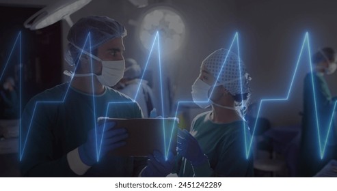 Image of cardiograph over diverse surgeons using tablet at hospital. Medicine, healthcare and digital interface concept concept digitally generated image. - Powered by Shutterstock