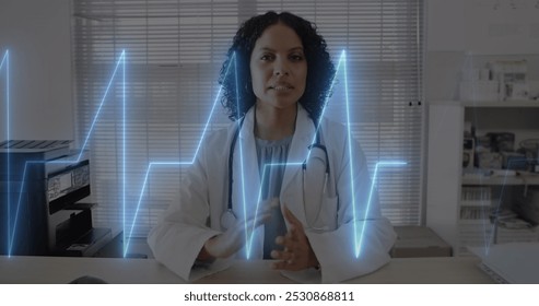 Image of cardiograph over happy biracial female doctor having image call. Medicine, technology and digital interface concept, digitally generated image. - Powered by Shutterstock