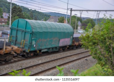 image of cargo container by train between a big city in Europe  