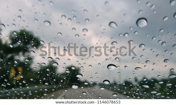 Image\
of a car\'s wind screen, driving through the\
rain.