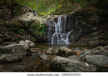 An image of Cascade Falls with rocks in the foreground at Patapsco State Park Avalon area.