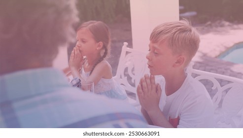 Image of caucasian family praying and having dinner. national siblings day and celebration concept digitally generated image. - Powered by Shutterstock