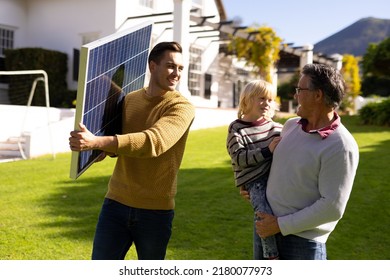 Image of caucasian father with solar panel, grandfather and grandson. Family, green energy, eco awareness and spending quality time together concept. - Powered by Shutterstock