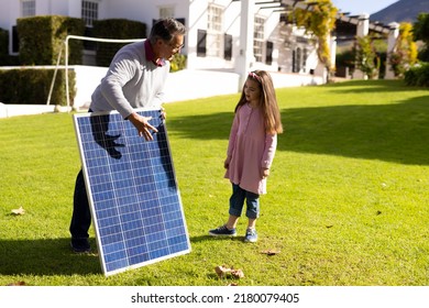 Image of caucasian grandfather with solar panel and granddaughter. Family, green energy, eco awareness and spending quality time together concept. - Powered by Shutterstock