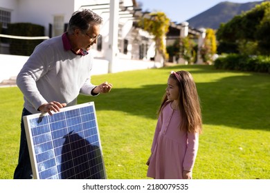 Image of caucasian grandfather with solar panel and granddaughter. Family, green energy, eco awareness and spending quality time together concept. - Powered by Shutterstock