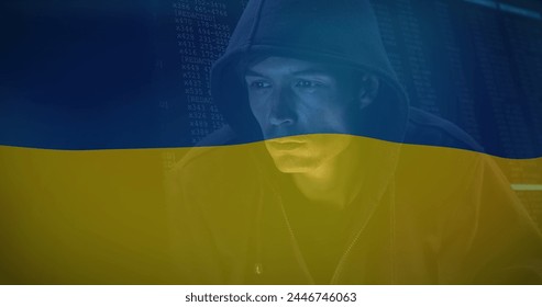 Image of caucasian male hacker over flag of ukraine. ukraine crisis, cyber warfare and international politics concept digitally generated image. - Powered by Shutterstock