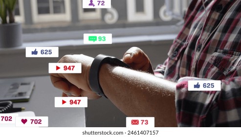 Image of changing numbers, icons in notification bars, biracial man using smartwatch. Digital composite, multiple exposure, business, growth, social media reminder and technology concept. - Powered by Shutterstock