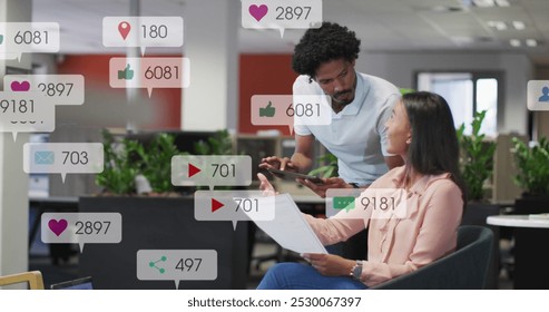 Image of changing numbers, icons in notification bars over diverse coworkers discussing reports. Digital composite, multiple exposure, social media reminder, planning, teamwork and technology. - Powered by Shutterstock