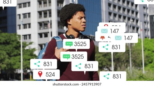 Image of changing numbers, icons over biracial man standing and looking at smartwatch. Digital composite, multiple exposure, business, growth, social media reminder and technology concept. - Powered by Shutterstock