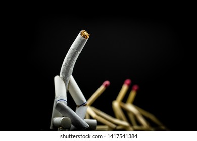 Image Of A Character Made Of Cigarette, With Matchsticks Next To It, On Black Background. Concept Of Bad Company. We Are Friends, A Toxic Friendship.