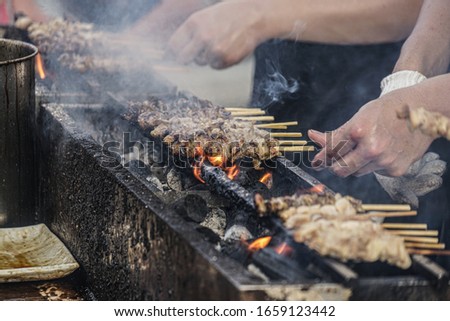 Similar – Man cooking on a barbecue