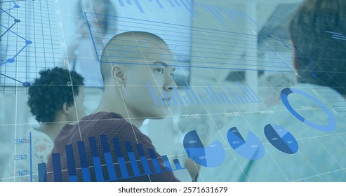 Image of charts processing data over diverse creatives having business image call. Network, data, finance, digital interface, business, teamwork and communication, digitally generated image.