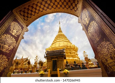 The image of Chedi Phra That Doi Suthep was photographed through the temple gate with a beautiful blue sky contrasting with the golden color of Chedi Phra That Doi Suthep in Chiang Mai, Thailand.