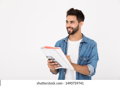 Image of cheerful bearded man writing in exercise book and smiling while looking aside isolated over white background - Shutterstock ID 1490759741