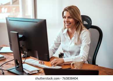 Image Of Cheerful Blonde Woman Working On Computer.