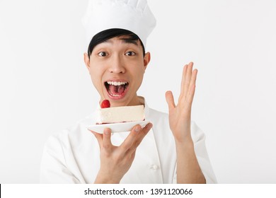 Image Of Cheery Chinese Chief Man In White Cook Uniform Smiling At Camera While Holding Platter With Tasty Cheesecake Isolated Over White Background