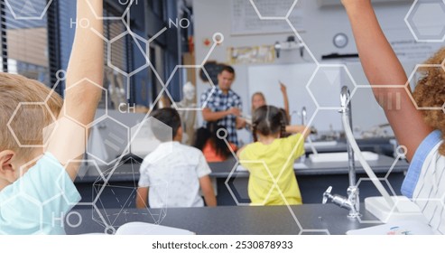 Image of chemical icons over diverse schoolchildren raising hands in classroom. national teacher day and celebration concept digitally generated image. - Powered by Shutterstock