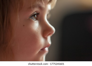 image of a child from profile while looking cartoon, note shallow depth of field
