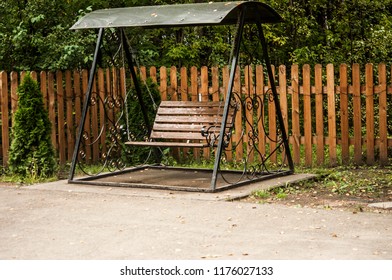 Image Of Childrens Swing Set In Green Park. 