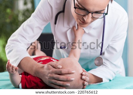 Image of child's neurologist diagnosing little boy