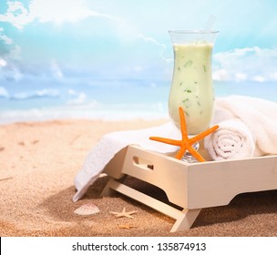 Image of chilled drink and some bath towels in white tray on the beach. Look at my portfolio for more cocktails.