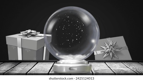 Image of christmas snow globe with snow falling and presents on black background. Christmas, festivity, tradition and celebration concept digitally generated image. - Powered by Shutterstock