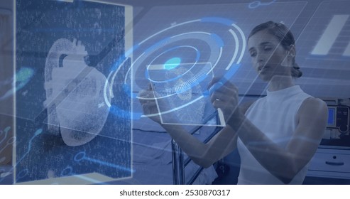 Image of circuit board, data processing over woman holding tablet. Global business, finances, digital interface, computing and data processing concept digitally generated image.