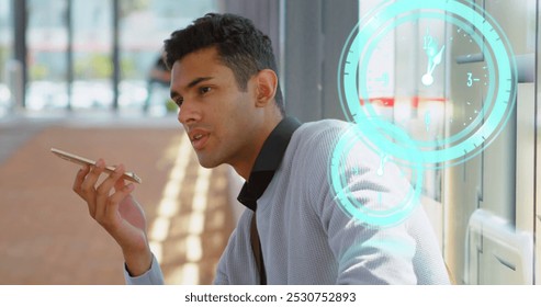 Image of clock moving over biracial businessman using smartphone. global business and digital interface concept digitally generated image. - Powered by Shutterstock