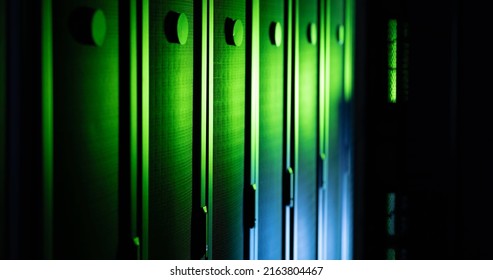 Image of close up of empty corridor with row of blue and green computer servers. global technology, data processing and connections concept.