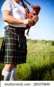 Image Close Up Of Man Enjoying Playing Pipes In Scotish Traditional Kilt On Green Outdoors Copy Space Summer Field 