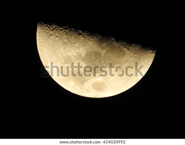 Image of close up the moon surface textured on\
dark night background