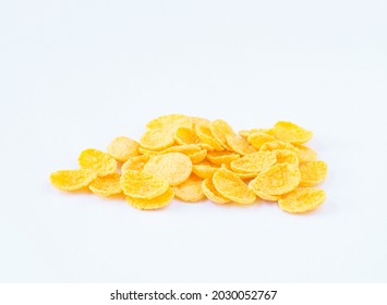 An image close-up isolated heap flakes, cornflakes, or muesli process from oat for breakfast healthy on white background.