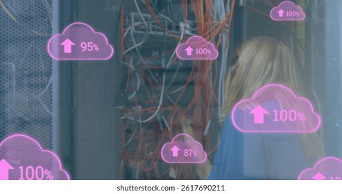 Image of cloud icons with growing numbers over caucasian woman in server room. global technology, data processing and digital interface concept digitally generated image.