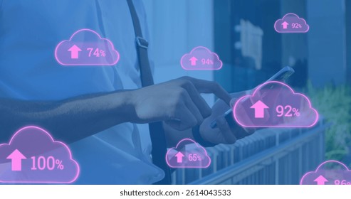 Image of clouds with arrows and percent going up over caucasian man using smartphone. global cloud computing, digital interface and data processing concept digitally generated image.