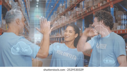 Image of clouds and data processing over diverse volunteers high fiving in warehouse. global shipping, cloud computing, business and data processing concept digitally generated image. - Powered by Shutterstock