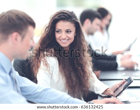 Image of collegues discussing documents and ideas at meeting in 