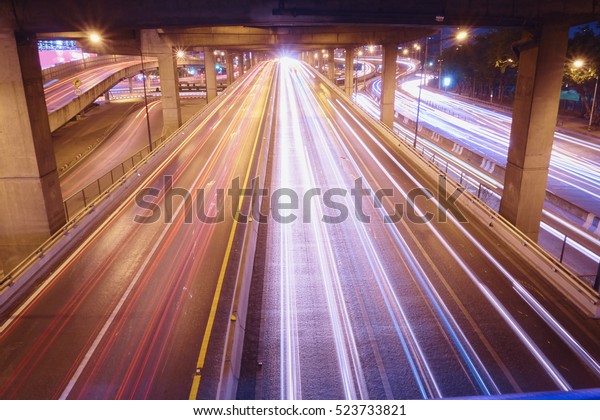 Image of color light of vehicle flow on\
road in the city night. Shot at Bangkok,\
Thailand