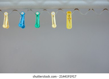 An Image Of Colorful Cloths Pins On A Clothesline. Colorful Clothespin.