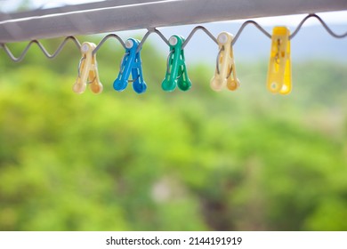 An Image Of Colorful Cloths Pins On A Clothesline. Colorful Clothespin.