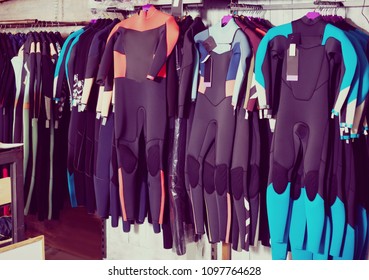 Image Of Colorful Wetsuit Hanging In The Modern  Shop For Surfing