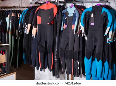 Image Of Colorful Wetsuit Hanging In The Modern  Shop For Surfing