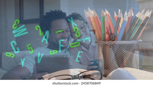 Image of colourful pencils over african american couple using tablet. Autism awareness month and celebration concept digitally generated image. - Powered by Shutterstock