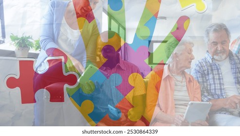 Image of colourful puzzle pieces hand over senior friends using electronic devices. autism, learning difficulties, support and awareness concept digitally generated image. - Powered by Shutterstock