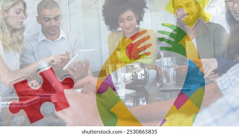 Image of colourful puzzle pieces ribbon over business colleagues using tablet. autism, learning difficulties, support and awareness concept digitally generated image. - Powered by Shutterstock