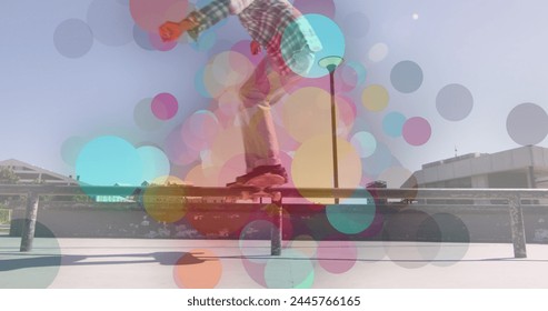 Image of colourful spots over biracial man skateboarding. global sport and digital interface concept digitally generated image. - Powered by Shutterstock