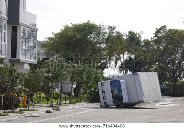 Image of a commercial truck flipped over due to high\
wind from Hurricane Irma
