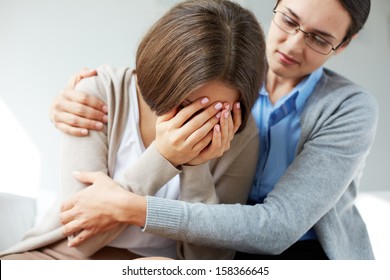 Image of compassionate psychiatrist comforting her crying patient - Powered by Shutterstock